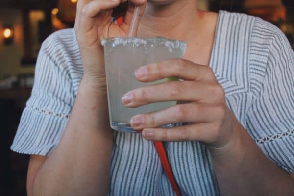 Woman drinking glass of tequila