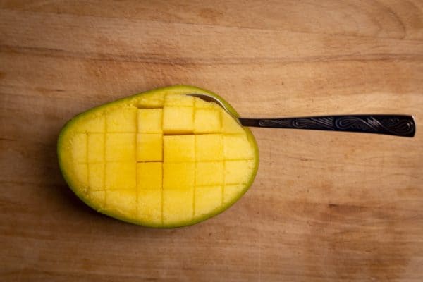 Mango prepared for eating with a spoon