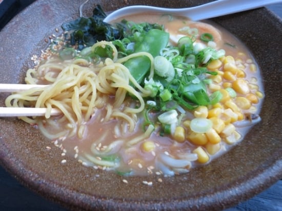 Miso ramen soup, a tablespoon and sticks