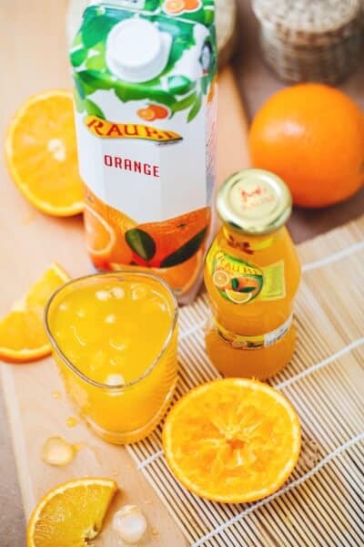 A glass of fresh orange juice and a bottle