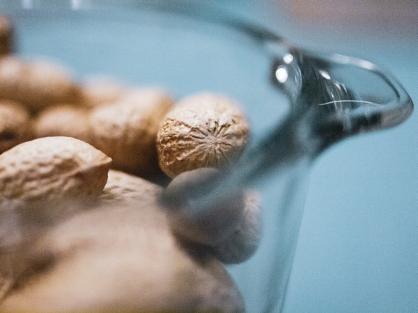 Unshelled peanuts in a glass bowl