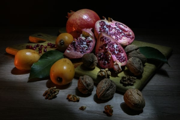 Walnuts and fruits on a cutting board