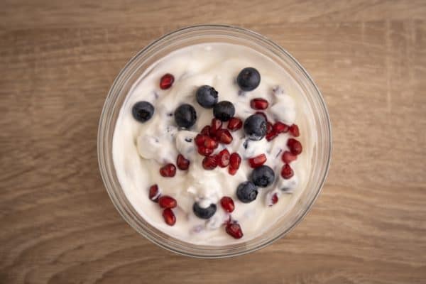 Yogurt with pomegranate seeds and blueberries