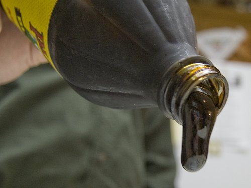 Pouring molasses from a bottle