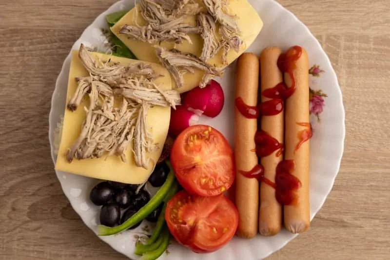 Breakfast: bread, veggies, sausages and ketchup