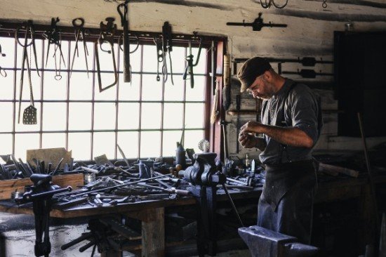 Busy craftsman in a toolshed