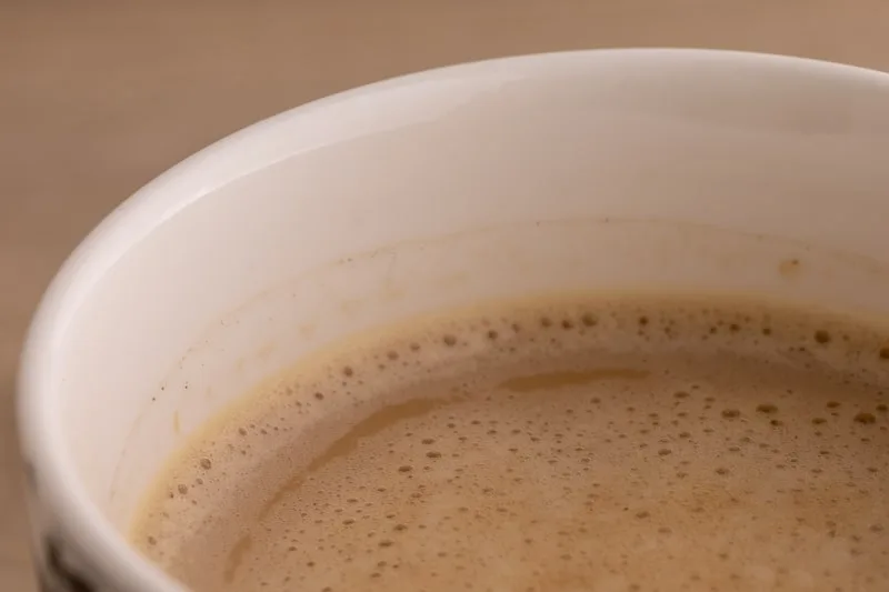 Coffee with creamer closeup