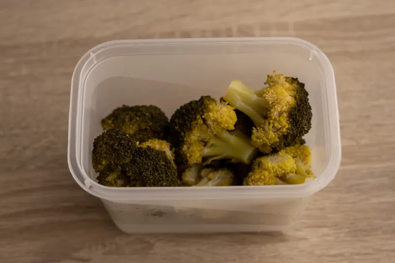 Cooked broccoli in an airtight container
