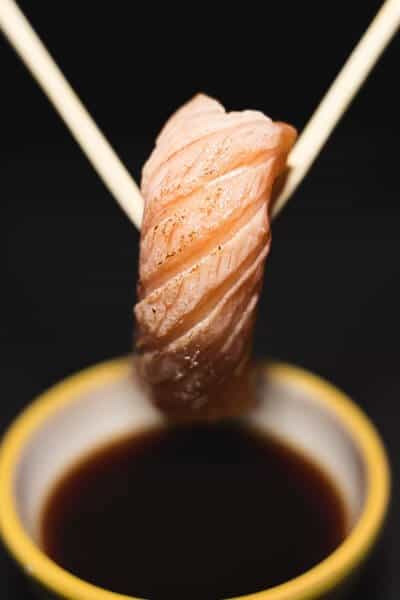 Dipping sushi in soy sauce