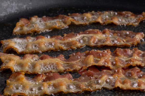 Frying bacon: closeup