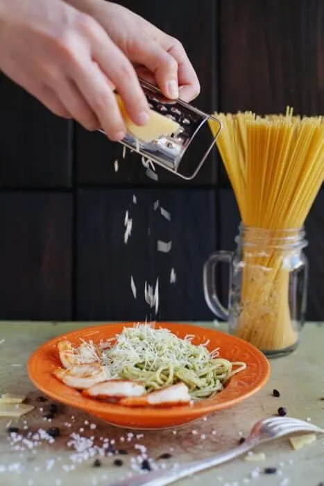 Grating cheese on spaghetti