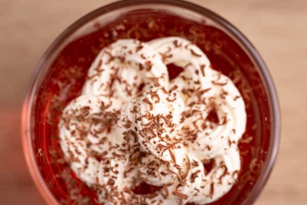 Jello and whipped cream, sprinkled with grated chocolate