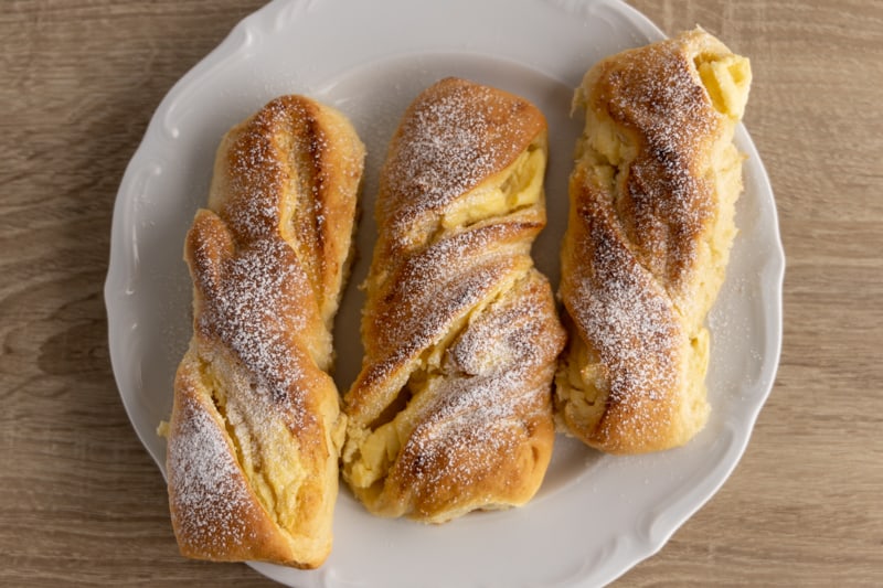 Just baked cheese buns dusted with powdered sugar