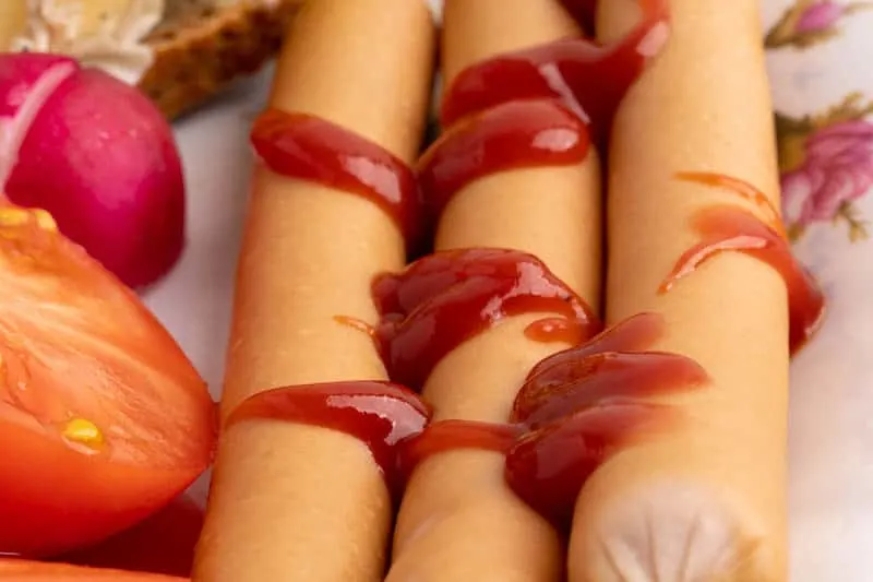 Ketchup on sausage: closeup