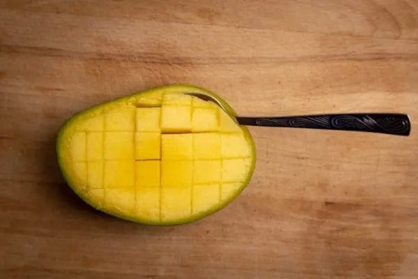Mango prepared for eating with a spoon