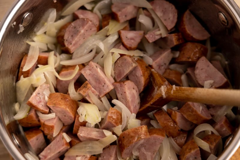 Sliced onions and kielbasa