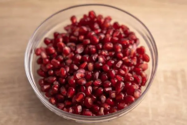 Pomegranate seeds in a glass bowl