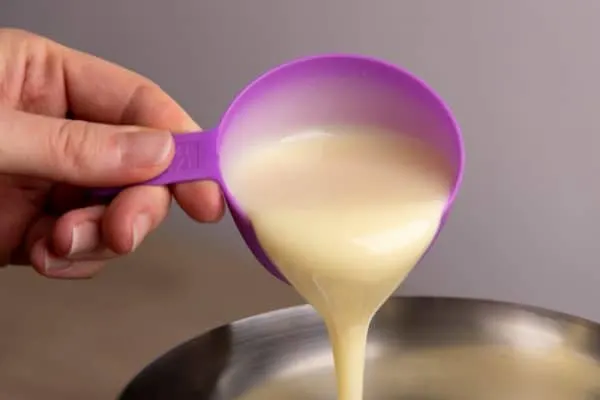 Pouring sweetened condensed milk