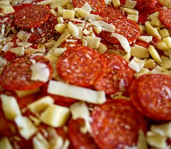 Preparing pepperoni pizza
