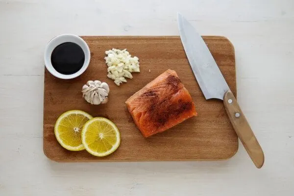 Salmon and seasonings on a cutting board