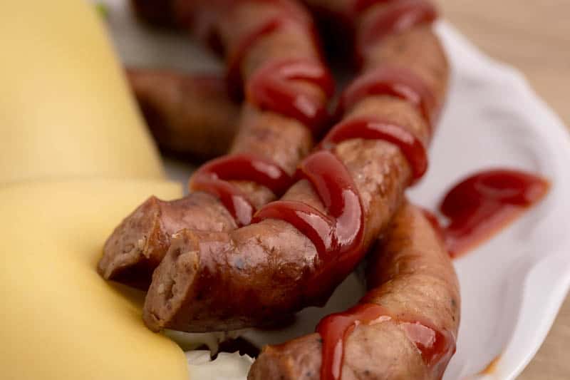 Sausage with ketchup: closeup