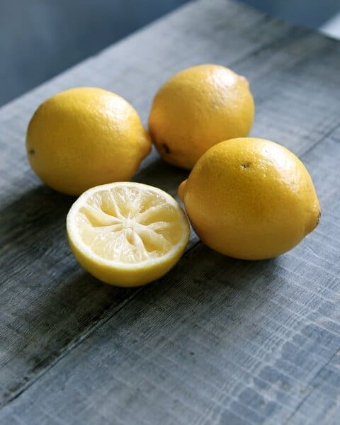 Three lemons on a wooden table