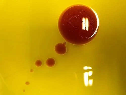 Drops of vinegar in oil