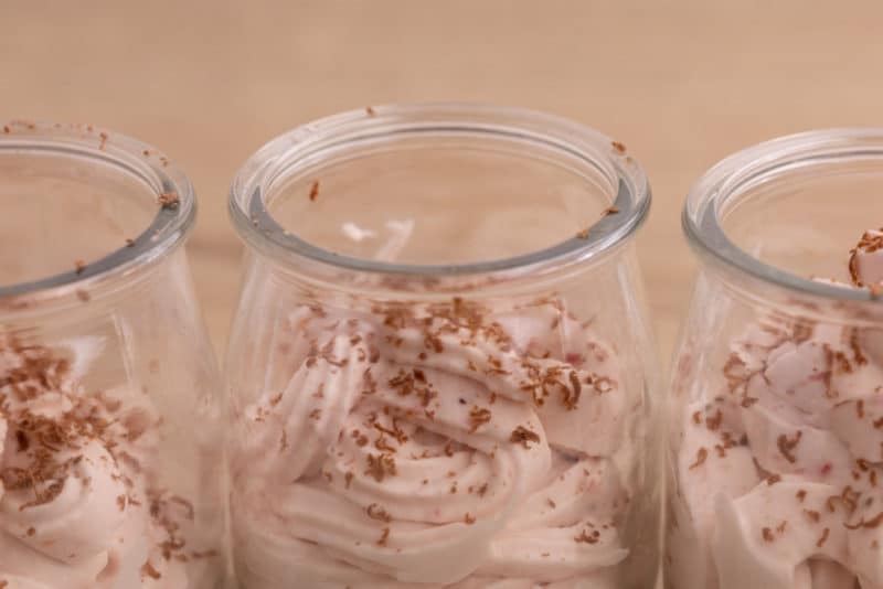 Whipped cream with strawberries topped with chocolate