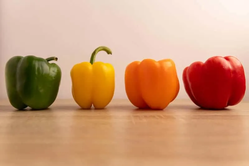 Whole bell peppers: green, yellow, orange, and red